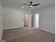 A spacious bedroom has carpet and a ceiling fan with two doors leading to other rooms at 1676 Fuma Leaf Way # 305, Mcdonough, GA 30253
