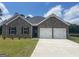 Charming single-story home featuring a brick facade, two-car garage, and well-manicured lawn at 1676 Fuma Leaf Way # 305, Mcdonough, GA 30253