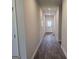 Hallway with neutral-colored walls and light at 1676 Fuma Leaf Way # 305, Mcdonough, GA 30253