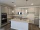 Kitchen featuring gray cabinets, stainless steel appliances, and a granite island at 1676 Fuma Leaf Way # 305, Mcdonough, GA 30253