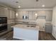 Modern kitchen features gray cabinets, granite countertops, stainless steel appliances, and an island at 1676 Fuma Leaf Way # 305, Mcdonough, GA 30253