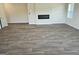 Open concept living room features vinyl floors and a modern electric fireplace insert at 1676 Fuma Leaf Way # 305, Mcdonough, GA 30253