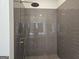 Modern shower featuring sleek gray tiling and a contemporary shower head at 1676 Fuma Leaf Way # 305, Mcdonough, GA 30253