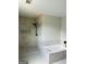 Bathroom features large walk-in shower with tile, and separate soaking tub with tile surround at 8035 Buffet Trl, Riverdale, GA 30296