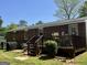 Backyard featuring a wood deck and a brick home at 107 Woodhaven Dr, Stockbridge, GA 30281