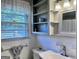 Bathroom featuring white tiled wall, sink, and window at 107 Woodhaven Dr, Stockbridge, GA 30281