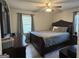 Bedroom featuring hardwood floors, a ceiling fan and a window at 107 Woodhaven Dr, Stockbridge, GA 30281