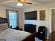 Bedroom featuring hardwood floors, a ceiling fan and a black dresser at 107 Woodhaven Dr, Stockbridge, GA 30281