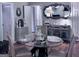 Elegantly decorated dining room with a modern mirror, glass table setting for a cozy, inviting atmosphere at 107 Woodhaven Dr, Stockbridge, GA 30281