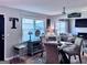 Light-filled dining area with a glass table and views into the comfortable living room, perfect for entertaining at 107 Woodhaven Dr, Stockbridge, GA 30281