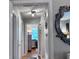 Hallway featuring decorative mirror with view of hardwood floors and bedroom at 107 Woodhaven Dr, Stockbridge, GA 30281