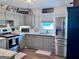 Well-equipped kitchen featuring gray cabinets, stainless steel appliances, and bright natural light at 107 Woodhaven Dr, Stockbridge, GA 30281