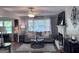 Cozy living room with decorative fireplace, hardwood floors, ceiling fan and a large window at 107 Woodhaven Dr, Stockbridge, GA 30281