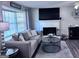 Cozy living room with a large bay window, a decorative fireplace, and comfortable seating at 107 Woodhaven Dr, Stockbridge, GA 30281