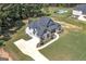 An aerial view of a luxurious home featuring a sprawling lawn, large driveway, and a backyard pool at 433 Wilson Dr, Mcdonough, GA 30252