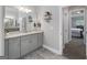 Well-lit bathroom features a double sink vanity with granite countertops and tile floors at 433 Wilson Dr, Mcdonough, GA 30252