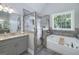 Bathroom features soaking tub, tiled shower, granite countertops, and tiled floors at 433 Wilson Dr, Mcdonough, GA 30252