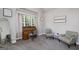 Comfortable bedroom area with a vintage desk, stylish seating, and natural light from a window at 433 Wilson Dr, Mcdonough, GA 30252