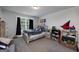 Bright bedroom with playful decor, large window, and carpeted floor offers a cozy personal space at 433 Wilson Dr, Mcdonough, GA 30252