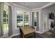 Bright dining area with large windows, wood table and chairs, and seamless connection to the rest of the house at 433 Wilson Dr, Mcdonough, GA 30252