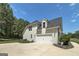 View of home's garage and side showing siding and brick exterior with well maintained landscaping at 433 Wilson Dr, Mcdonough, GA 30252
