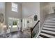 Elegant foyer with staircase, hardwood floors, and plenty of natural light from large windows at 433 Wilson Dr, Mcdonough, GA 30252
