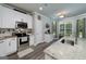 Modern kitchen features granite countertops, stainless steel appliances, and an adjacent dining area bathed in natural light at 433 Wilson Dr, Mcdonough, GA 30252