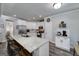 Well-lit kitchen with white cabinets, stainless steel appliances, granite countertops, and island seating at 433 Wilson Dr, Mcdonough, GA 30252