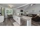 Bright kitchen featuring a large island with sink and dishwasher, seamlessly connecting to the dining and living areas at 433 Wilson Dr, Mcdonough, GA 30252