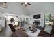 Bright, open-concept living room with a brick fireplace, vaulted ceiling, and modern finishes that leads to a white kitchen at 433 Wilson Dr, Mcdonough, GA 30252