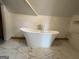 Elegant bathroom features a standalone tub, marble flooring, and bright, inviting natural light at 435 Jackson St, Locust Grove, GA 30248