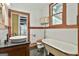 Bathroom features a claw foot tub, vintage toilet, vessel sink and wood trim at 435 Jackson St, Locust Grove, GA 30248