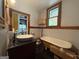 Bathroom featuring clawfoot tub, updated sink, and vintage fixtures at 435 Jackson St, Locust Grove, GA 30248
