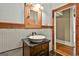 A bathroom showing a vanity with vessel sink and a wood-trimmed mirror at 435 Jackson St, Locust Grove, GA 30248