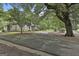 Traditional home with a circular driveway, mature tree, surrounded by mature trees and lush greenery at 435 Jackson St, Locust Grove, GA 30248