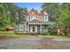 Charming two-story home with a welcoming front porch and a well-manicured lawn and beautiful accent turrets at 435 Jackson St, Locust Grove, GA 30248