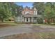 Charming two-story home with a welcoming front porch and a well-manicured lawn with beautiful accent turrets at 435 Jackson St, Locust Grove, GA 30248