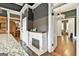 Charming kitchen featuring a decorative fireplace, open doorway, granite countertops, and dark hardwood floors at 435 Jackson St, Locust Grove, GA 30248