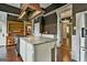 Open concept kitchen with an island, dark wood floors, modern appliances and unique architectural details at 435 Jackson St, Locust Grove, GA 30248