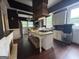Kitchen featuring granite countertops, an island with cooktop, and white cabinets at 435 Jackson St, Locust Grove, GA 30248