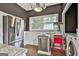 Well-lit kitchen featuring stainless steel appliances, laundry and an eating area, ideal for everyday convenience at 435 Jackson St, Locust Grove, GA 30248
