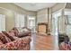 Spacious living room boasts hardwood floors, neutral walls, natural light, and a charming fireplace at 435 Jackson St, Locust Grove, GA 30248