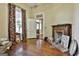A living room showing wood floors, a fireplace, floral drapes and neutral walls at 435 Jackson St, Locust Grove, GA 30248