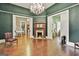 Brightly lit living room featuring hard wood floors and detailed trim work at 435 Jackson St, Locust Grove, GA 30248