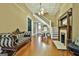 Inviting living room featuring hardwood floors, fireplace, piano, and staircase with a light, neutral color palette at 435 Jackson St, Locust Grove, GA 30248