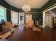Spacious living room with chandelier and hardwood flooring needs some updating at 435 Jackson St, Locust Grove, GA 30248