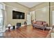 Open-concept living room featuring hardwood floors, neutral paint, and large windows for natural light at 435 Jackson St, Locust Grove, GA 30248