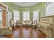 Living room featuring wood floors, neutral walls, vintage furniture and bright lighting at 435 Jackson St, Locust Grove, GA 30248