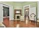 Living room showing fireplace, light green walls, vintage furniture, and wood floors at 435 Jackson St, Locust Grove, GA 30248