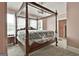 Bedroom with a four-poster bed frame, chandelier, neutral walls, and large windows at 435 Jackson St, Locust Grove, GA 30248